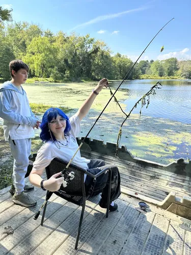 Members fishing at a pond on a field trip