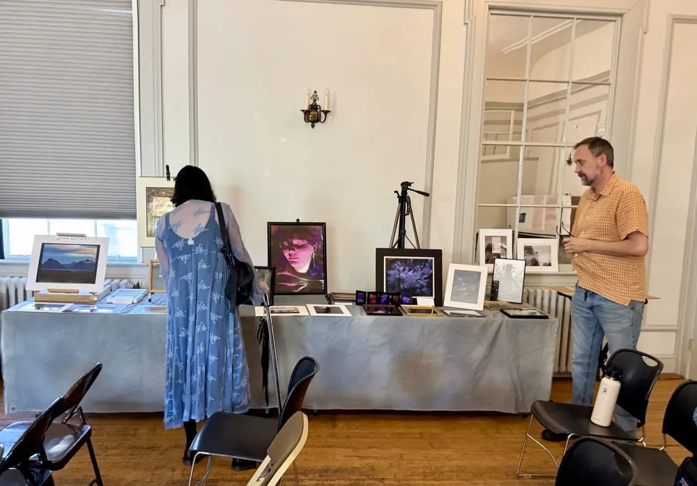 A variety of photographs displayed on a large table.